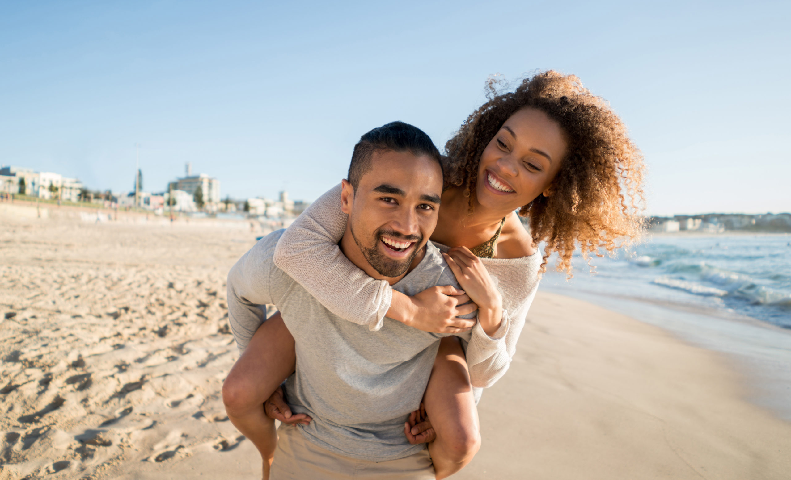 Couple laughing on the beach during a weekend getaway in Miami Beach